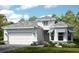 Charming single-Gathering home featuring a welcoming two-car garage and manicured landscaping at 29845 Imperati Blvd, Wesley Chapel, FL 33543