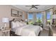 Serene bedroom featuring large windows, elegant decor, and ample natural light at 29845 Imperati Blvd, Wesley Chapel, FL 33543