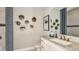Elegant bathroom with a designer mirror, vanity and modern wall decor at 29863 Imperati Blvd, Wesley Chapel, FL 33543