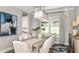 Elegant dining room with contemporary chandelier and large window at 29863 Imperati Blvd, Wesley Chapel, FL 33543