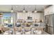 Bright kitchen with stainless steel appliances, a kitchen island, and seating for entertaining at 29863 Imperati Blvd, Wesley Chapel, FL 33543
