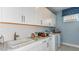 Functional laundry room with ample storage and modern appliances at 29863 Imperati Blvd, Wesley Chapel, FL 33543