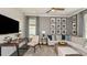Well-lit living room featuring designer furnishings and a large TV for relaxing at 29863 Imperati Blvd, Wesley Chapel, FL 33543