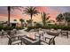 Relax in the outdoor patio with fire features, comfortable seating and lush landscaping at sunset at 29863 Imperati Blvd, Wesley Chapel, FL 33543