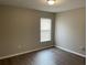 Bedroom featuring wood-look flooring, window, and neutral wall color at 3112 E 8Th Ave, Tampa, FL 33605