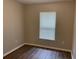 Cozy bedroom with wood-look floors, window, and light-colored walls creating a relaxing ambiance at 3112 E 8Th Ave, Tampa, FL 33605