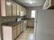 Functional kitchen featuring ample cabinet space, white appliances, and neutral tile flooring at 3112 E 8Th Ave, Tampa, FL 33605
