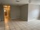 Neutral living room has access to the bathroom, bedroom, and kitchen with tile floors and ceiling fan at 3112 E 8Th Ave, Tampa, FL 33605