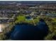 Extensive aerial view of a lake community that highlights the pool and pier at 3150 Granite Ridge Loop, Land O Lakes, FL 34638