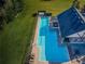 Aerial view from directly above the community pool showing lane lines, deck, cabana, and plenty of seating at 3150 Granite Ridge Loop, Land O Lakes, FL 34638