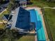 Aerial view looking down on the community pool, cabana, and green space that surround the area at 3150 Granite Ridge Loop, Land O Lakes, FL 34638