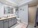 Bathroom featuring granite counters, a large mirror, and a tiled shower for a refreshing space at 3358 Tanglewood Trl, Palm Harbor, FL 34685