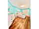 Bright bedroom with light-blue walls, wood-look flooring, and ample natural light at 3358 Tanglewood Trl, Palm Harbor, FL 34685