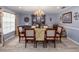 Elegant dining room featuring wood floors, chandelier, and a large china cabinet for stylish entertaining at 3358 Tanglewood Trl, Palm Harbor, FL 34685