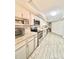 Bright kitchen features stone countertops, stainless appliances, and tiled backsplash at 3358 Tanglewood Trl, Palm Harbor, FL 34685