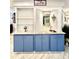 Charming wet bar area with granite countertop, blue cabinetry, and glass shelving at 3358 Tanglewood Trl, Palm Harbor, FL 34685