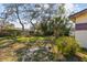 A spacious backyard featuring a large mature tree providing ample shade at 4002 W Gray St, Tampa, FL 33609