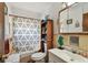 Modest bathroom with a shower-tub combo, single sink vanity, and a medicine cabinet at 4002 W Gray St, Tampa, FL 33609