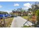 Exterior of a single-story home with a long driveway and a covered carport at 4002 W Gray St, Tampa, FL 33609