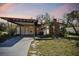 Charming single-story home featuring a carport, brick chimney and quaint front yard at 4002 W Gray St, Tampa, FL 33609