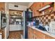 The kitchen features wood cabinetry, a tile backsplash, and a view into the dining room at 4002 W Gray St, Tampa, FL 33609