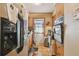 Efficient kitchen design with wood cabinets, stainless steel fridge, and tiled floor at 4002 W Gray St, Tampa, FL 33609