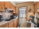 Features of the kitchen include wood cabinets, tile backsplash, and stainless steel appliances at 4002 W Gray St, Tampa, FL 33609