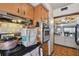 Kitchen features wood cabinets, tiled backsplash, oven, and view to dining room at 4002 W Gray St, Tampa, FL 33609