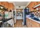 Kitchen featuring wood cabinets, tile backsplash, and oven with range hood at 4002 W Gray St, Tampa, FL 33609