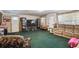 Traditional living room features a carpeted floor, plenty of sunlight, and a comfortable sofa at 4002 W Gray St, Tampa, FL 33609