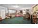 Traditional living room features a carpeted floor, plenty of sunlight, and comfortable sofas and chair at 4002 W Gray St, Tampa, FL 33609