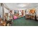 Traditional living room features a carpeted floor, plenty of sunlight, and comfortable sofas and chair at 4002 W Gray St, Tampa, FL 33609