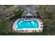 Aerial view of the community pool with lounge chairs and a pool house at 4535 Kennewick Pl, Riverview, FL 33578