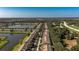 Aerial view showcasing the community layout with its tidy streets, pond, and landscaping at 4535 Kennewick Pl, Riverview, FL 33578