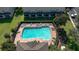 Aerial view of the community pool, surrounded by townhomes and manicured lawns at 4535 Kennewick Pl, Riverview, FL 33578