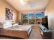 Cozy bedroom with a large window overlooking the backyard and a ceiling fan at 4535 Kennewick Pl, Riverview, FL 33578