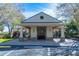 Clubhouse exterior, with a covered patio, brick facade, and well-manicured landscaping at 4535 Kennewick Pl, Riverview, FL 33578
