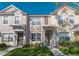 Inviting two-story townhome featuring a covered entryway, well-maintained lawn, and charming architectural details at 4535 Kennewick Pl, Riverview, FL 33578