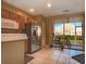 Bright kitchen featuring stainless steel appliances, tile floors, and sliding glass doors to the outside patio at 4535 Kennewick Pl, Riverview, FL 33578