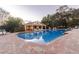 Community pool and clubhouse, surrounded by lounge chairs for relaxation and enjoyment at 4535 Kennewick Pl, Riverview, FL 33578