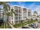 Condominium building featuring private screened balconies, parking, and tropical landscaping at 4904 38Th S Way # 316, St Petersburg, FL 33711