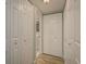 Hallway featuring luxury vinyl plank flooring and multiple storage closets at 4904 38Th S Way # 316, St Petersburg, FL 33711
