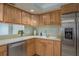 Bright kitchen featuring light countertops, stainless steel appliances, and wooden cabinets at 4904 38Th S Way # 316, St Petersburg, FL 33711