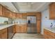 Kitchen with wooden cabinets, stainless steel appliances, ceiling fan, and light countertops at 4904 38Th S Way # 316, St Petersburg, FL 33711