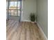 Bright living room featuring wood floors, light blue walls, and natural light from a sliding glass door at 4904 38Th S Way # 316, St Petersburg, FL 33711