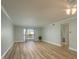 Open-concept living room featuring hardwood floors, neutral paint, ceiling fan, and sliding doors at 4904 38Th S Way # 316, St Petersburg, FL 33711
