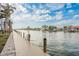 Scenic waterfront view of a canal with a long wooden pier and beautiful homes in the background at 4904 38Th S Way # 316, St Petersburg, FL 33711