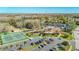 A high-angle view captures a community center with a pool, tennis courts, and parking at 4955 Grist Mill Cir, New Port Richey, FL 34655