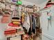 A packed walk-in closet with shelving, clothing, boxes and other items at 4955 Grist Mill Cir, New Port Richey, FL 34655