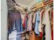 Walk-in closet with ample hanging space and upper shelving for organized storage at 4955 Grist Mill Cir, New Port Richey, FL 34655